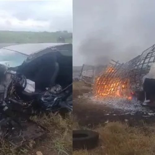 Caminhão baú é consumido pelo fogo após colidir com carro de passeio